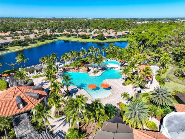 Aerial view of residential area with a pool and a nearby body of water