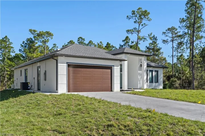 Modern exterior featuring a prominent brown garage door and a concrete driveway