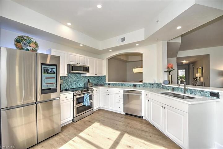 Updated kitchen including well-thought out appliances w/range/convection oven, low-profile hood microwave & state of the art 4-door refrigerator w/updated counters, undermount sink, faucet & more!