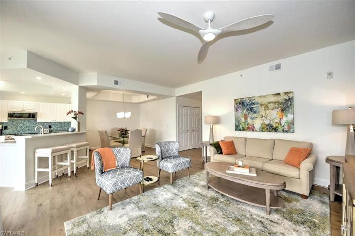 Gorgeous open concept living room overlooks lanai with triple slider and waterfront!