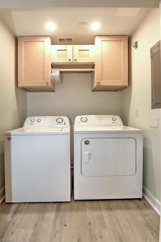 Laundry room with upgraded maple cabinetry & hanging rack!