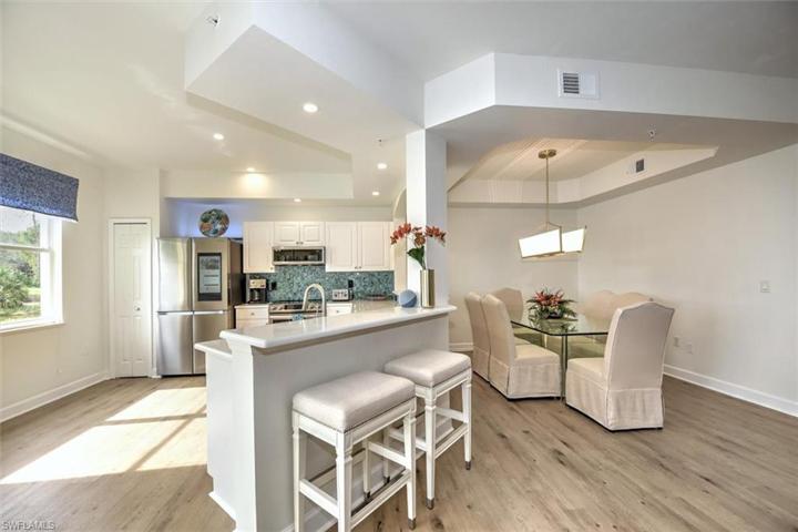 Peninsula breakfast bar height overlooks kitchen and open-concept to dining room!
