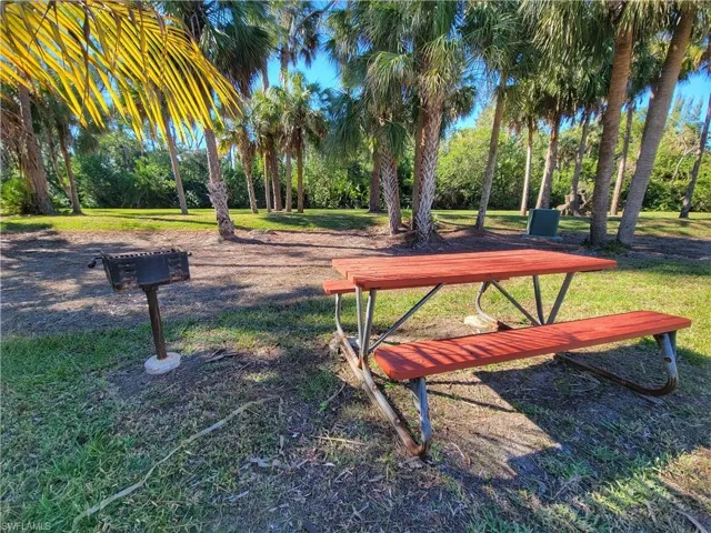 View of property's community with a yard