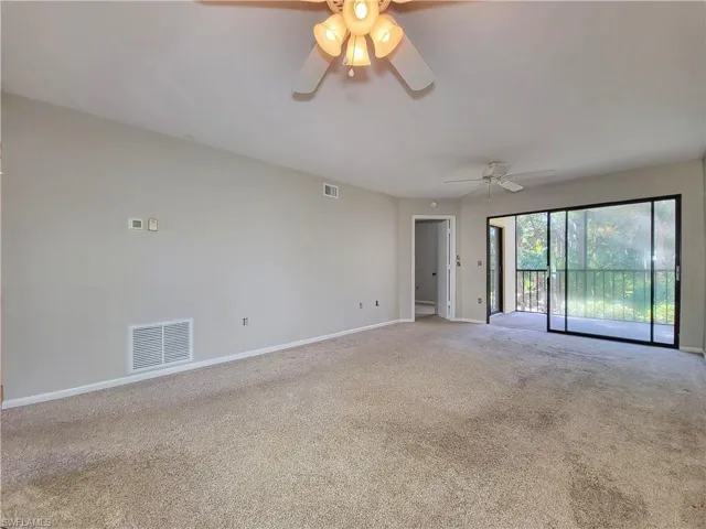 Empty room featuring carpet floors and ceiling fan