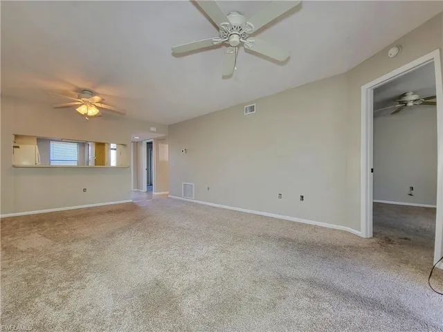 Unfurnished living room featuring carpet