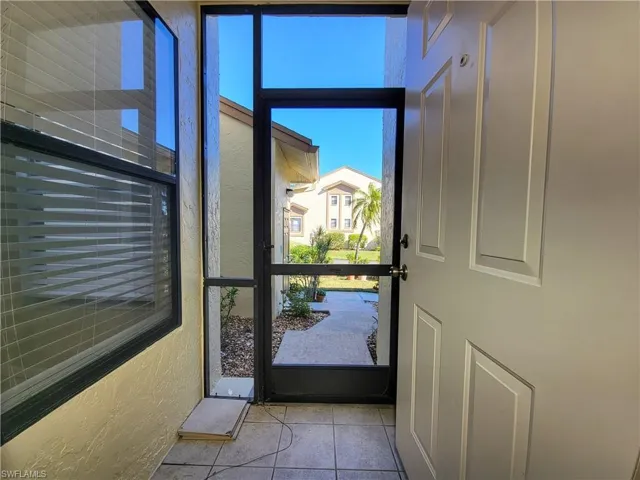 Doorway to outside with light tile patterned flooring