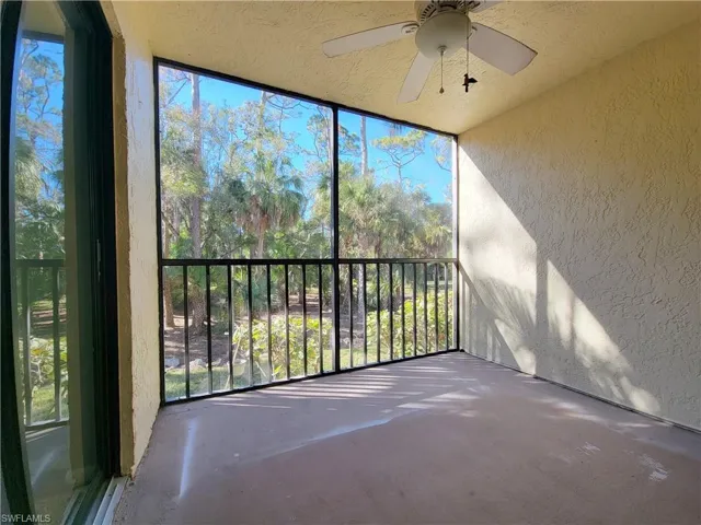 Unfurnished sunroom with ceiling fan