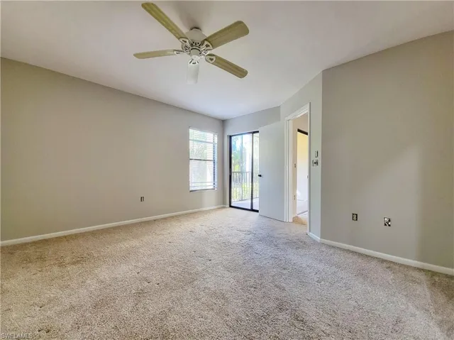 Spare room with ceiling fan and light colored carpet