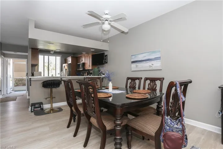 Dining space with light wood-style flooring and ceiling fan