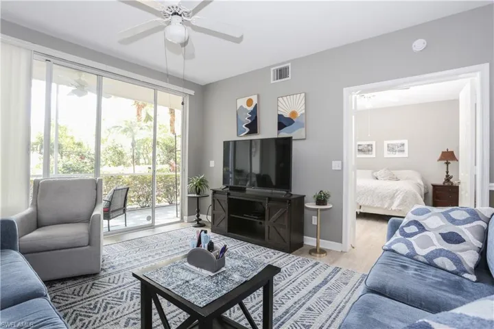 Living area with a ceiling fan and light wood finished floors