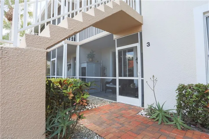 View of patio featuring a sunroom