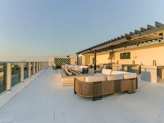 View of patio with an outdoor living space with a fire pit