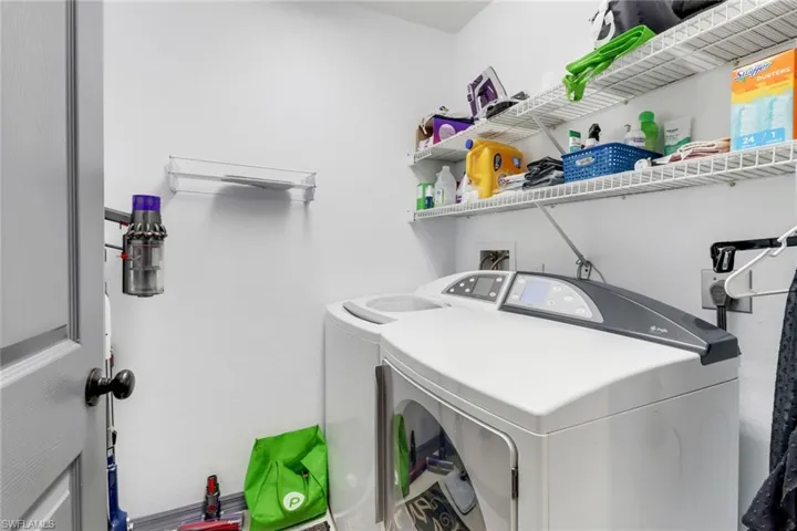 Washroom with washing machine and clothes dryer