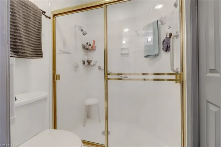 Bathroom with toilet and walk in shower