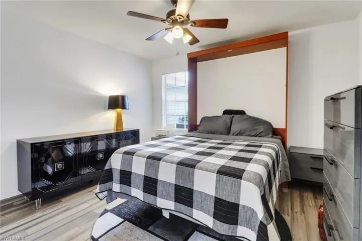 Bedroom with wood-type flooring and ceiling fan