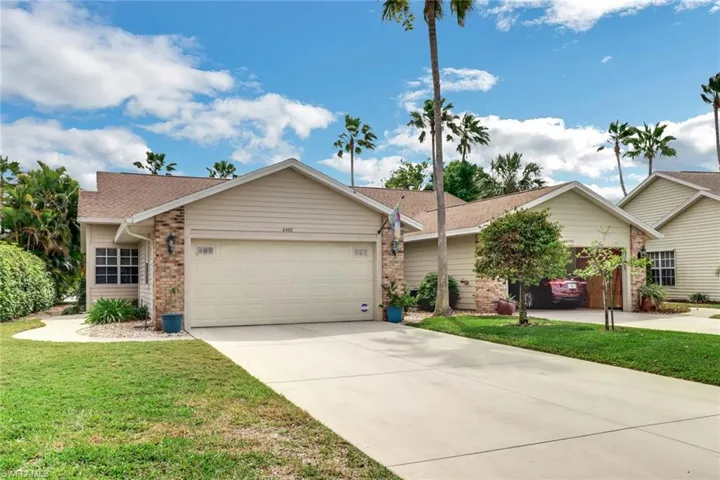 Ranch-style home featuring a garage and a front yard