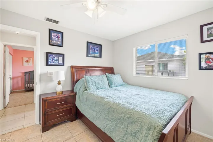 Bedroom with a ceiling fan, baseboards, visible vents, and light tile patterned floors