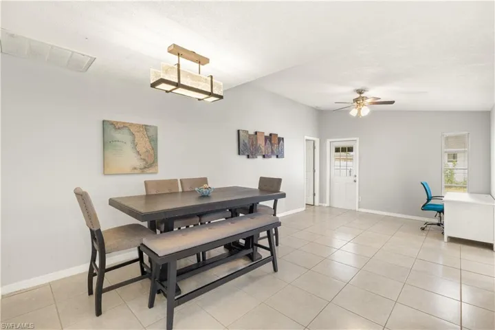 Dining room featuring baseboards, a ceiling fan, light tile patterned flooring, and visible vents
