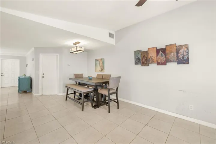 Dining room featuring a ceiling fan, baseboards, visible vents, and light tile patterned floors