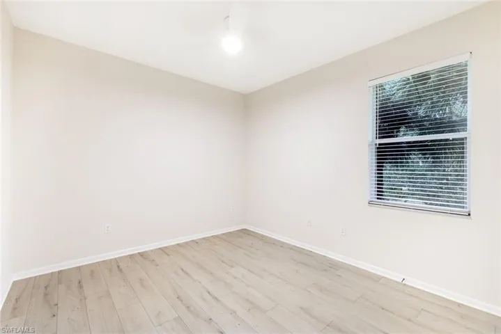 Spare room featuring plenty of natural light and light hardwood / wood-style floors