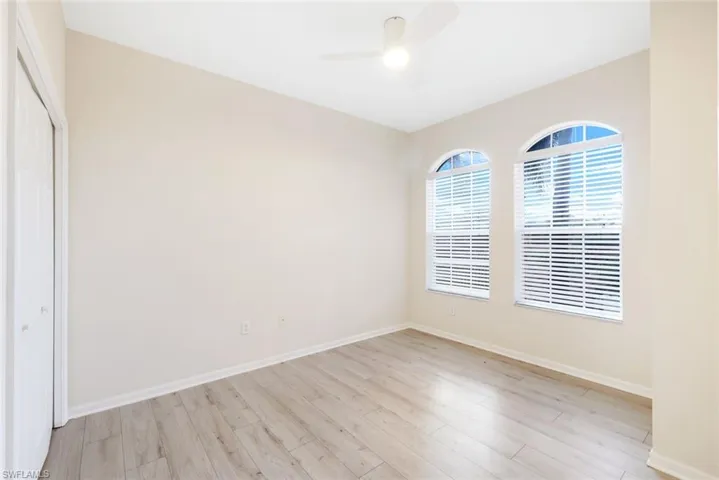 Unfurnished bedroom featuring ceiling fan, light hardwood / wood-style floors, and a closet