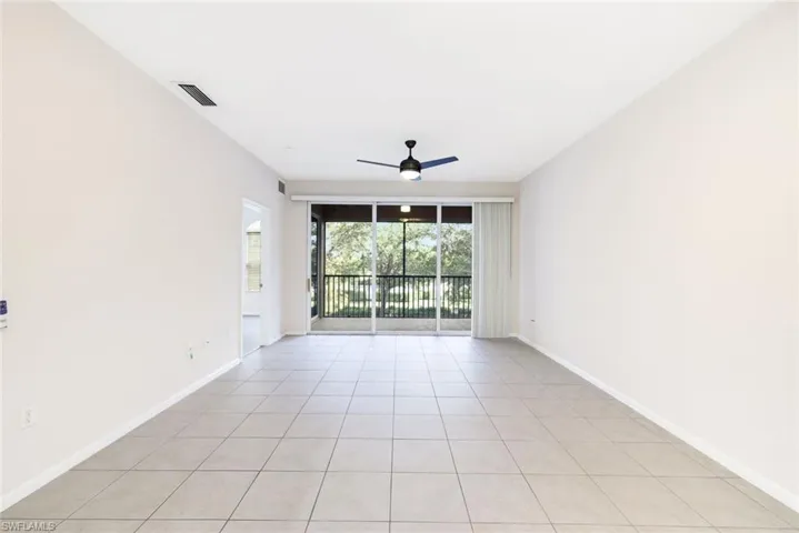 Tiled spare room with ceiling fan