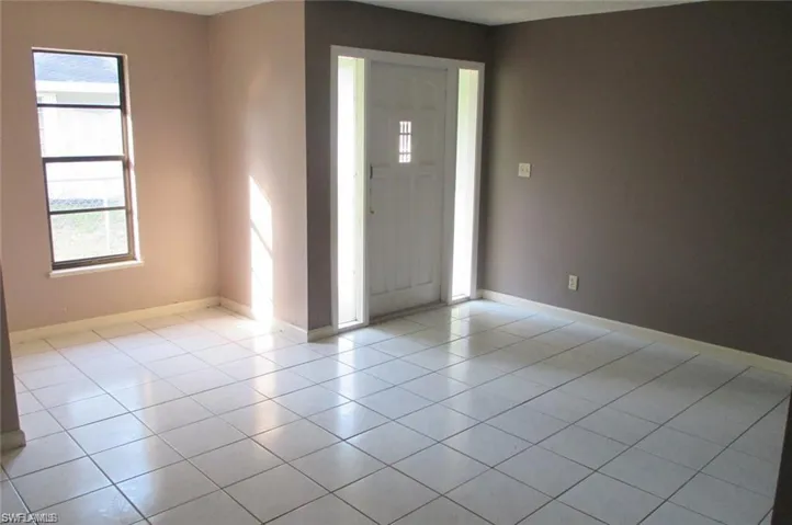 Entryway with healthy amount of natural light and light tile patterned floors
