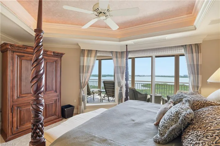 Tranquil bedroom featuring beautiful water vistas and direct lanai access.