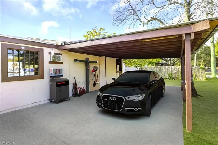 View of parking with a carport