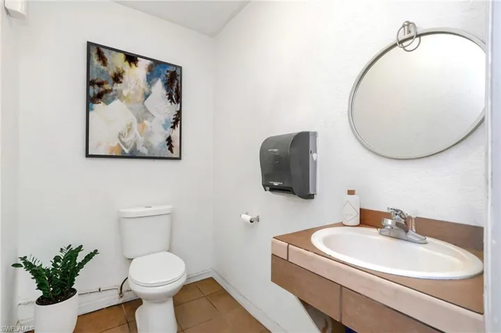 Half bath featuring tile patterned floors and vanity