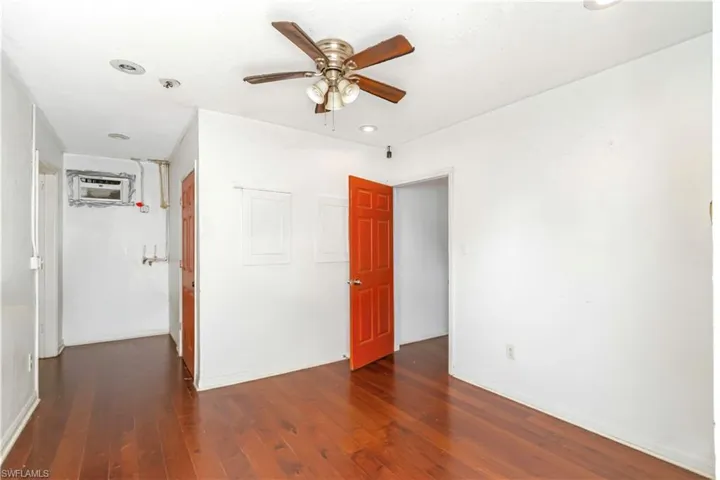 Unfurnished room with dark wood finished floors, ceiling fan, and recessed lighting