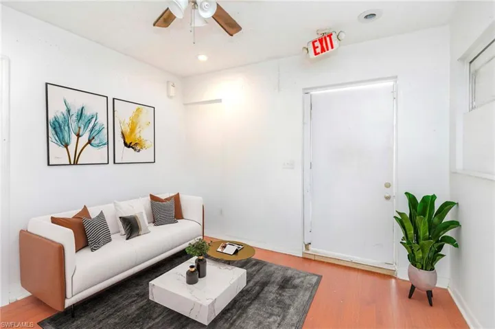 Living area with light wood-type flooring, a ceiling fan, and recessed lighting