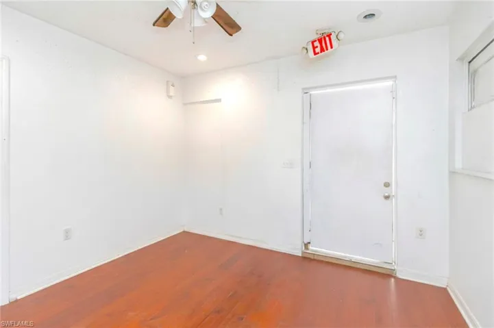 Empty room with hardwood / wood-style floors, ceiling fan, and recessed lighting