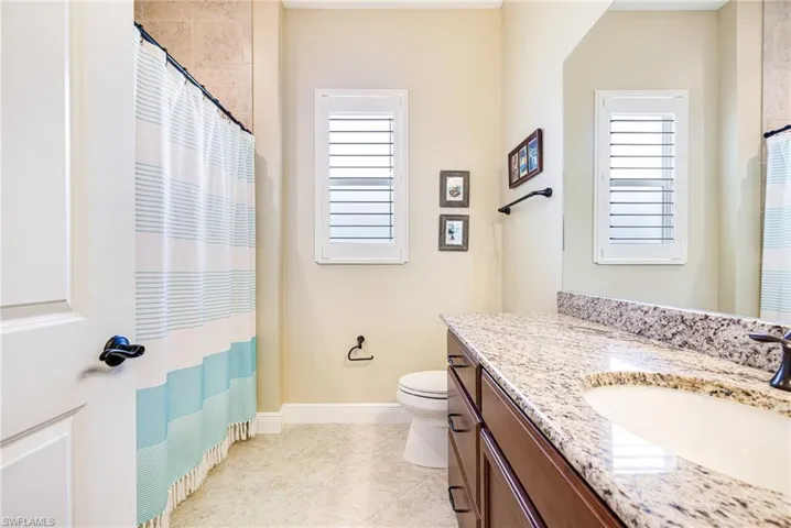 Full guest bath featuring vanity, Shower/tub, window with plantation shutters.