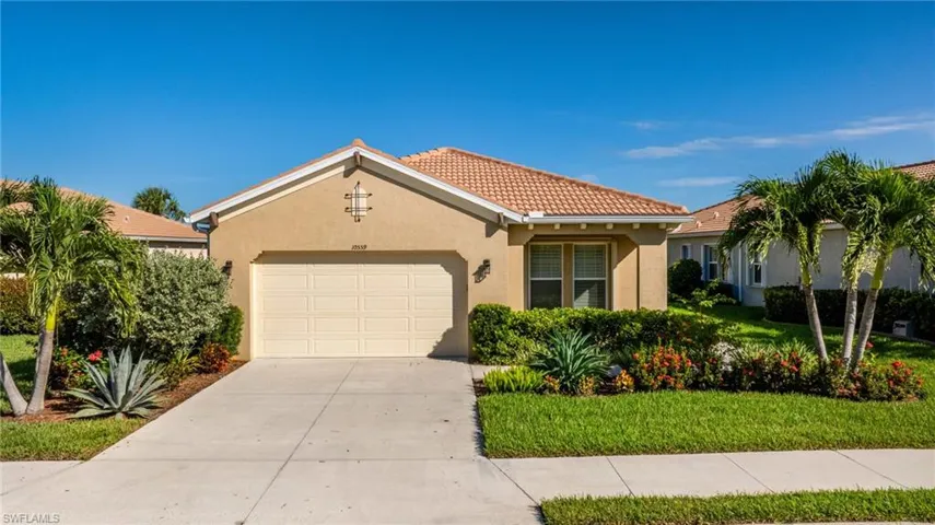 Curb appeal! Custom lush landscaping to welcome you home! Sidewalks, two car garage entry, tiled roof. A perfect Florida home.