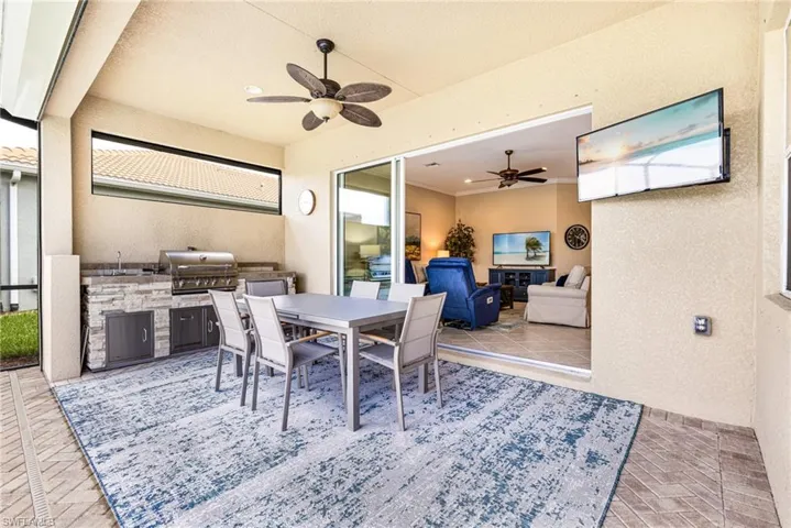 View of Lanai featuring area for grilling, outdoor dining space flowing in and out of the homes living space.