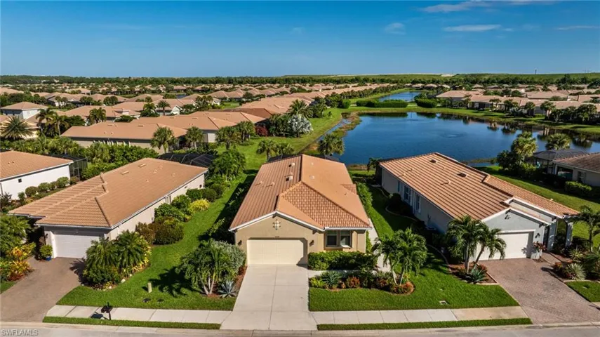 Lovely home location from streetside through to lakeside. Showing off the custom lush landscaping, tiled roof, Florida style!