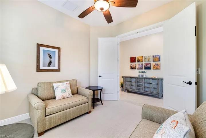 Den/Flex room used as a sitting area and for guest overflow. Features solid french doors, a ceiling fan, two pull out beds and window with plantation shutters.