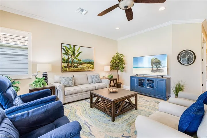 Great room area with crown molding, a ceiling fan, recessed lighting, and light tile on the diagonal