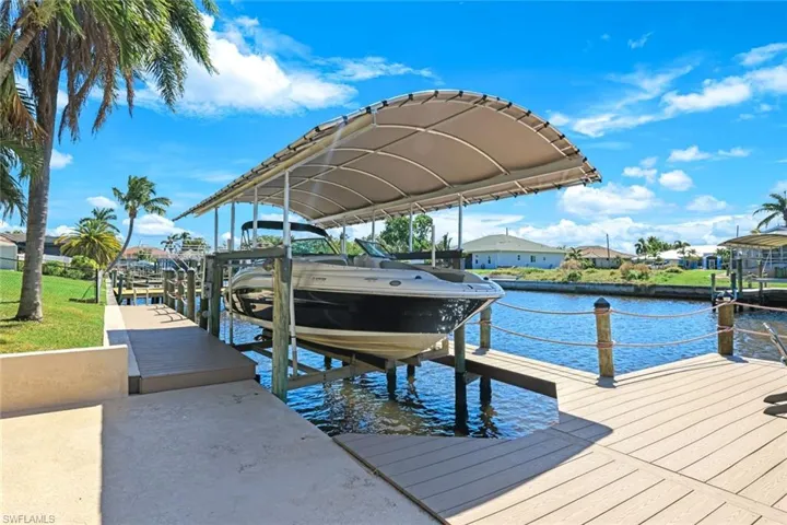 View of dock with a water view and boat lift