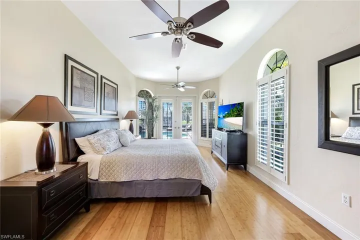 Bedroom with ceiling fan, baseboards, french doors, light wood-style floors, and access to outside