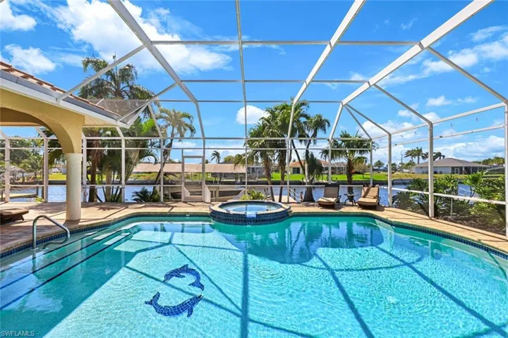 View of swimming pool with a patio, a lanai, and a pool with connected hot tub