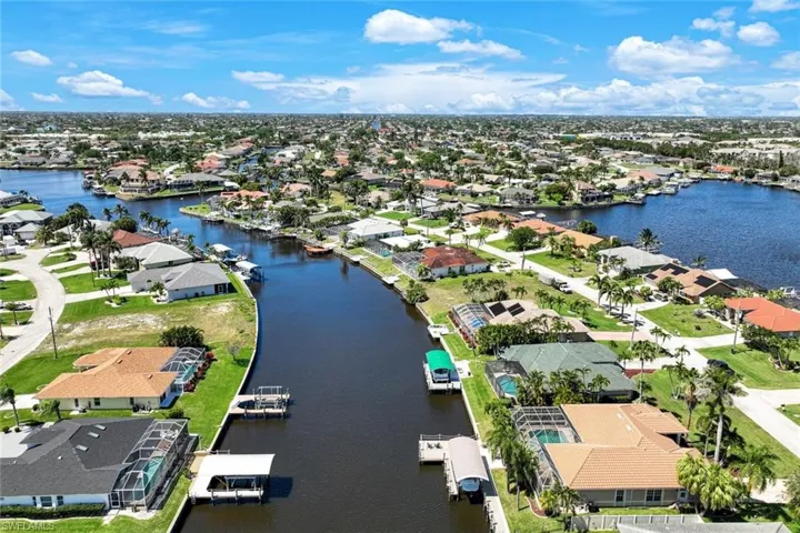 Birds eye view of property with a residential view and a water view