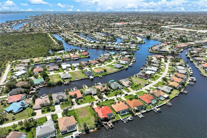 Drone / aerial view with a residential view and a water view