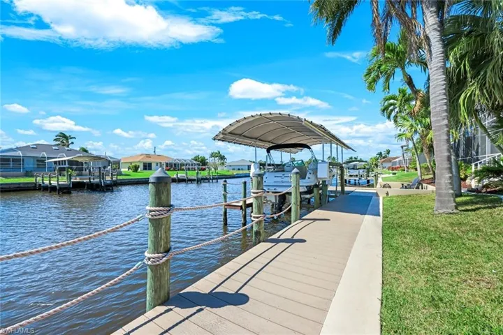 Dock area with a yard, a water view, and boat lift