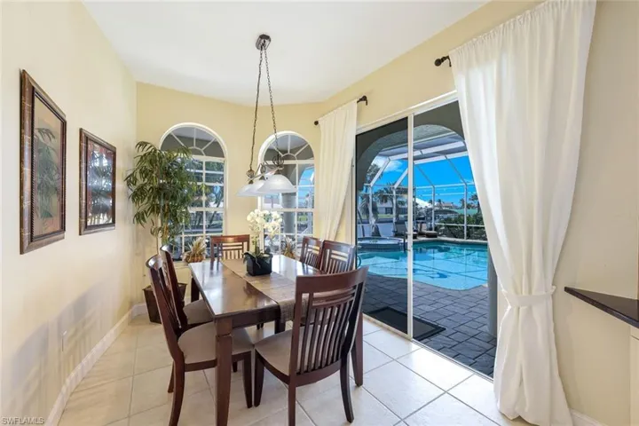 Dining area featuring light tile patterned floors and baseboards