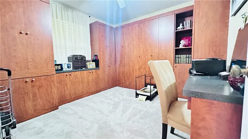 Office featuring carpet flooring and a textured ceiling