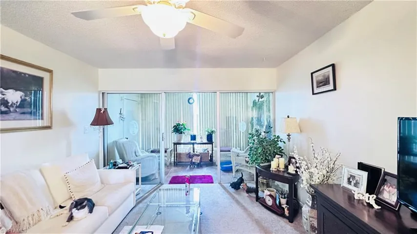 Living area featuring a textured ceiling and ceiling fan