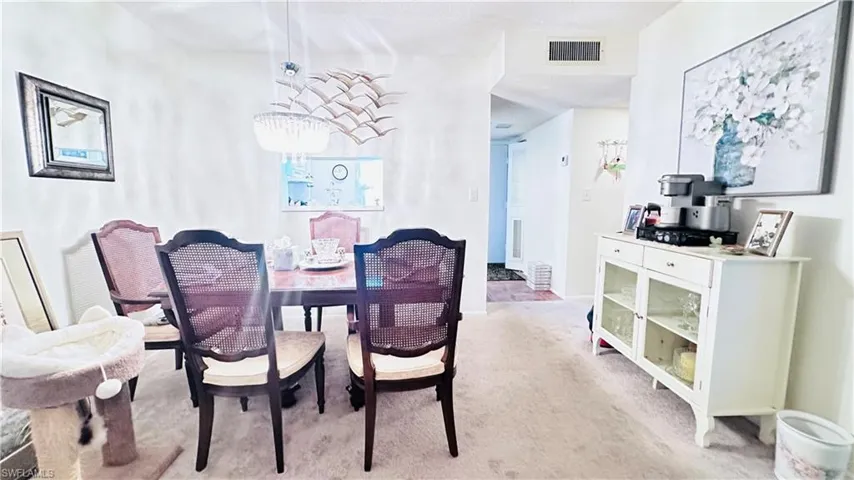 Dining space with light colored carpet