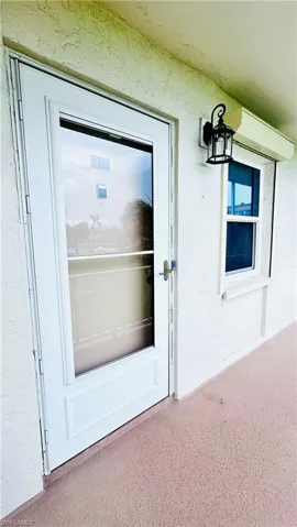 View of exterior entry featuring stucco siding